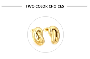 Detail of polished gold knot stud earrings with a small heart charm on white background