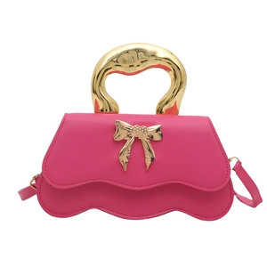 Hot pink textured leather mini square bag with metallic bow and artistic gold handle