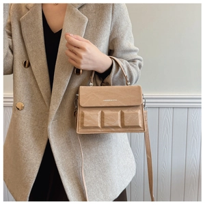 Detailed side view of khaki embossed chocolate box bag with FASHION & BAGS logo