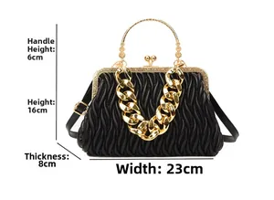 Detail view of black quilted leather handbag with gold handle and dimension markers
