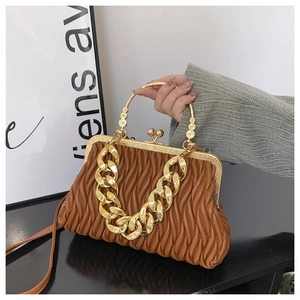 Detailed view of brown ruched bag with golden metal frame and thick chain link strap