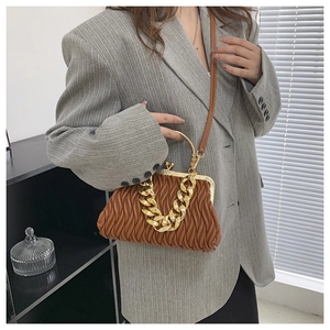 Brown quilted leather shell bag with gold chain handle and vintage metal clasp detail