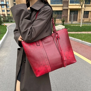 Retro red leather tote bag with woven straps and tassel detail for women's daily commute