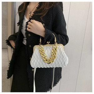 Detail of white pleated cloud bag with gold chain handle and ivory PU leather texture