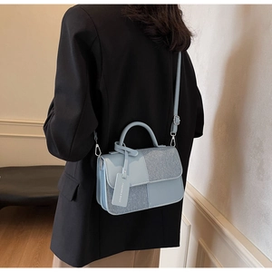 Petit sac à bandoulière bleu clair porté par un modèle montrant la taille réelle