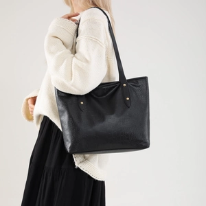 Chic black crocodile embossed tote bag with gold rivets and spacious casual style