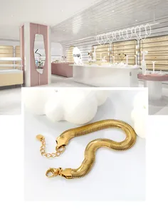 Close-up of 18k gold plated flat snake chain bracelet with lobster clasp and extender