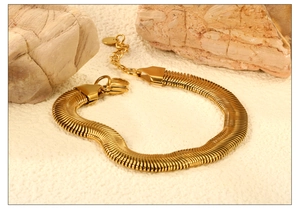 Detailed close-up of 18K gold mesh chain bracelet with lobster clasp and extender