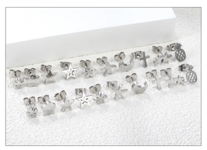 Macro shot of silver stainless steel stud earring set featuring star and flower shapes