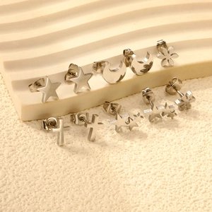 Fashionable stainless steel earring set featuring star, moon and flower shaped studs