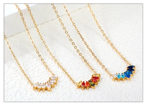 Close-up of gold-plated necklaces with colorful marquise-cut zircon gemstone pendants
