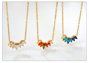 Detailed macro of rhinestone petal pendants in clear, rainbow, and blue-green colors
