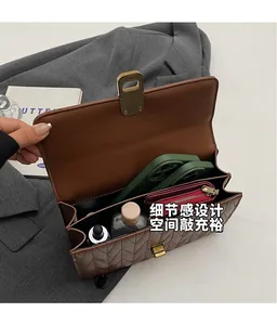 Detailed interior of the quilted shoulder bag showing multiple compartments and storage space