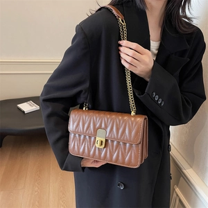 Brown quilted leather crossbody bag with V-pattern stitching and gold chain strap