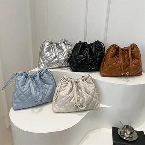 Quilted drawstring bucket bags in multi-color metallic and matte finishes with bow detail