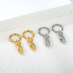 Artistic gold and silver female torso pendant hoop earrings in minimalist style
