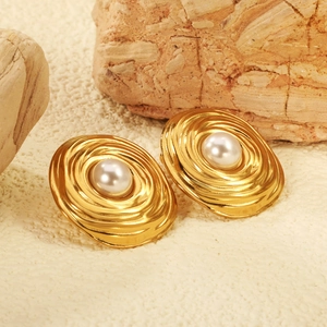 Vintage 18K gold-plated wavy flower earrings with pearls on a natural stone background
