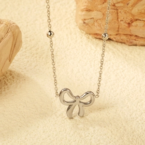 Elegante collana con ciondolo a fiocco d'argento e piccole perle su catena sottile
