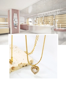 Detailed close-up of heart-shaped zircon pendant on golden stainless steel chain