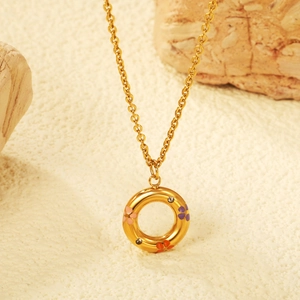 Golden circle necklace with colorful floral motifs and zircons on a natural stone base