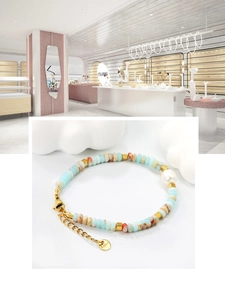 Detail of colorful stone beaded bracelet with white pearl and gold stainless steel clasp