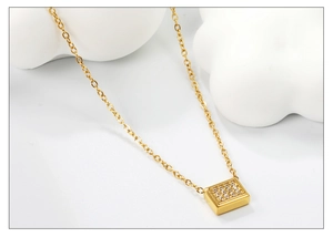 Detail of gold rectangle pendant with cubic zirconia inlay on elegant O-chain