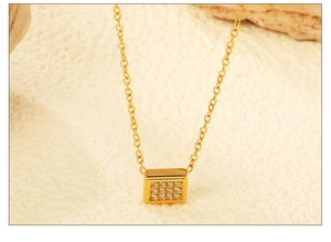 Detailed close-up of a square gold pendant necklace with 16 micro-set clear crystals