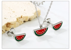 Detail of watermelon fruit jewelry set with vibrant red and green enamel coating