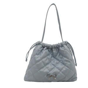 Fog blue quilted tote bag with drawstring closure and delicate metal bow detail