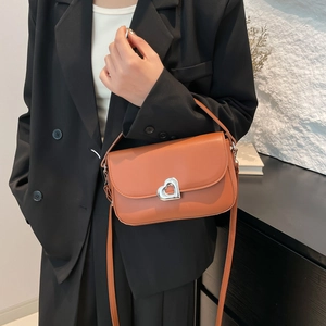 Caramel retro underarm square bag with silver heart buckle shown on model