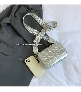Silver PU crossbody bag with rhinestones shown next to a smartphone for size comparison