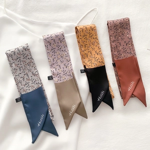 Detail of floral skinny silk scarves with Hilldi embroidery on elegant satin fabric