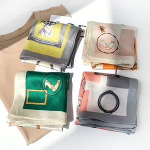 Detail of four printed silk scarves with vintage patterns and elegant satin texture