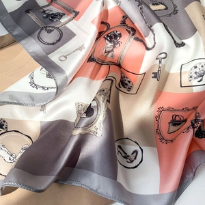 Close-up of vintage print silk scarf showing smooth texture and French retro patterns