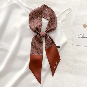 Floral rust brown skinny scarf twilly tied on a white satin strap with brand detail
