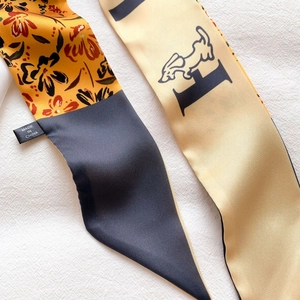 Gros plan détaillé du foulard twilly avec imprimé pied-de-poule et fleurs sur tissu blanc