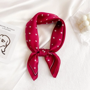 Elegant fuchsia silk scarf with white boat pattern tied in a stylish bow knot