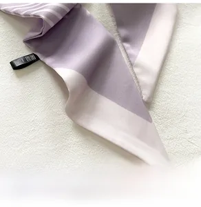 Macro shot of purple and white striped silk scarf with elegant glossy satin texture