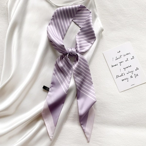Elegant purple striped silk twilly scarf tied on a white satin dress for a stylish look