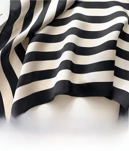 Close-up of stripes and high-quality machine-stitched edges on a satin silk scarf