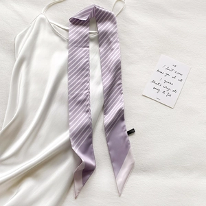 Detail showing the smooth satin texture of the purple and white striped skinny scarf