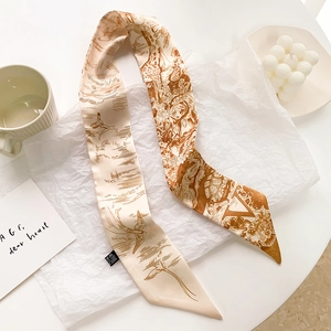Gros plan détaillé d'un foulard long et étroit en soie avec motif d'oiseau