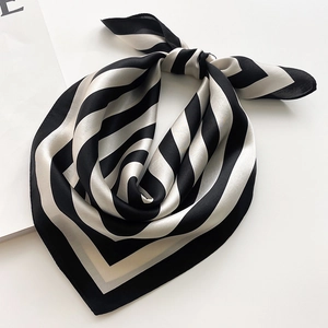 Classic black and white striped silk square scarf tied in a stylish neck bow