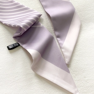 Detail of lavender striped twilly scarf showing fabric texture and design label
