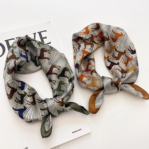 Premium silk square scarf featuring elegant horse print in green and caramel tones