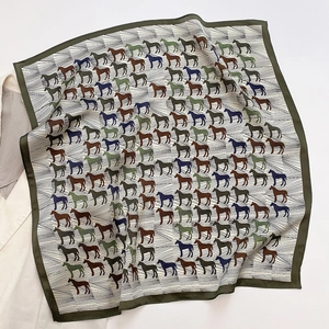 Detail of silk square scarf featuring colorful horse print and striped geometric patterns