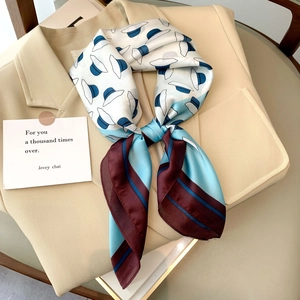 Elegant floral print silk scarf styled with beige blazer neck for a chic look