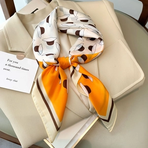 Elegant floral print satin square scarf with vintage hat patterns on a beige suit