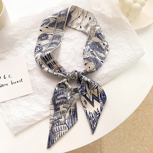 Détail d'un foulard étroit en soie noué en boucle avec imprimé abstrait bleu élégant