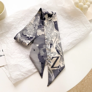 Détail d'un foulard long en soie avec imprimé lettre Z bleu marine et motifs artistiques